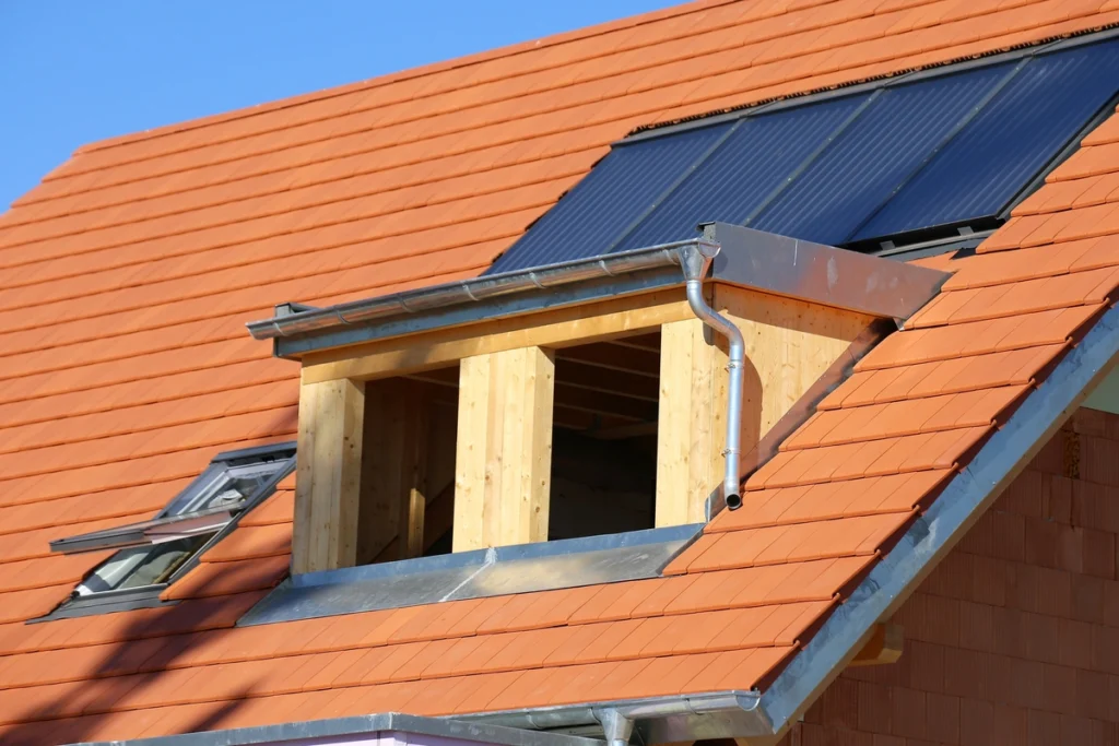 unfinished dormer on a red roof