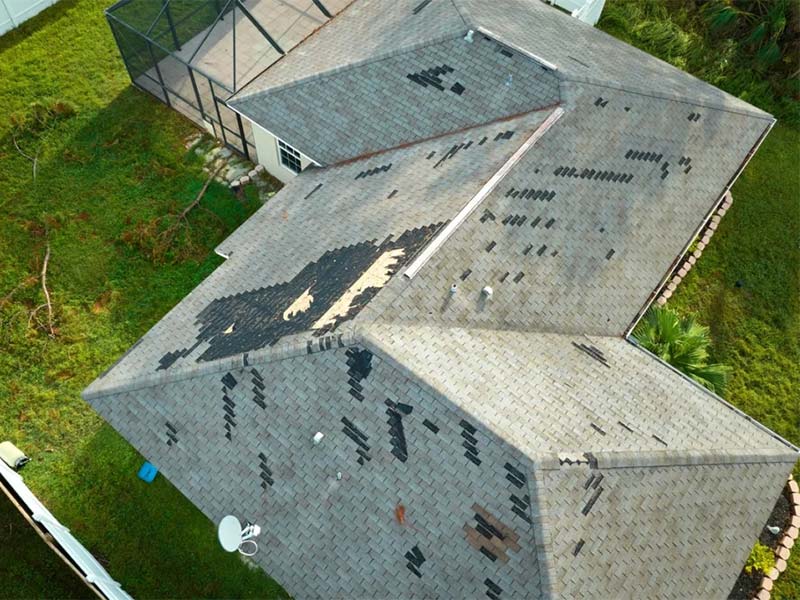 Missing roof shingles in need of a tarp