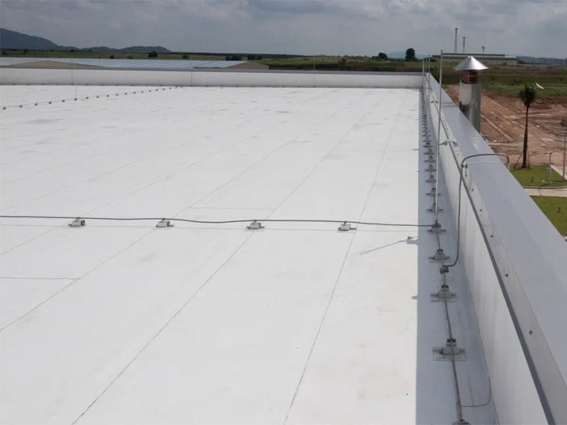 Repaired PVC flat roof with edge fasteners.