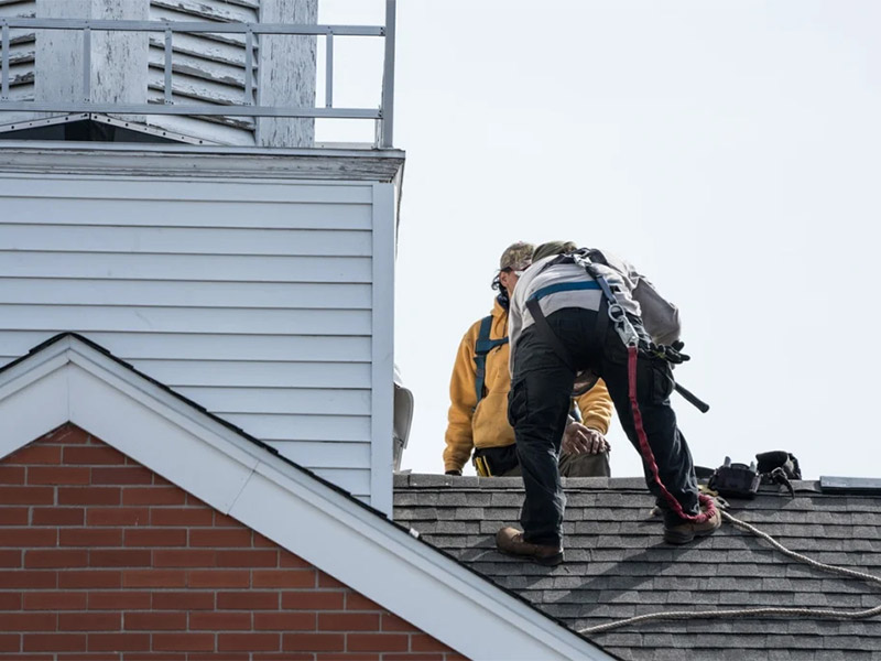 Roofer showing new roof installation on a house