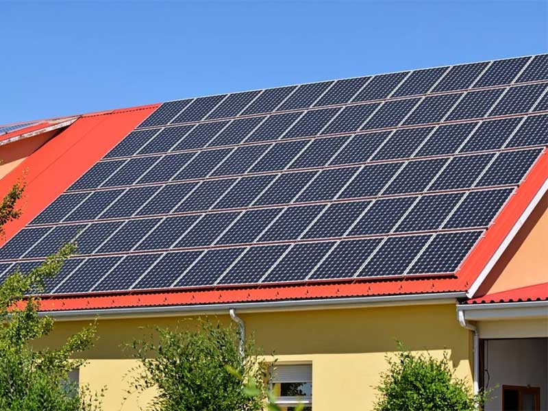 Large rooftop solar panel installation on a house.