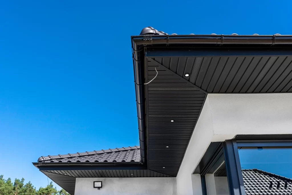 Closed roof eaves with black soffits installed for roof ventilation