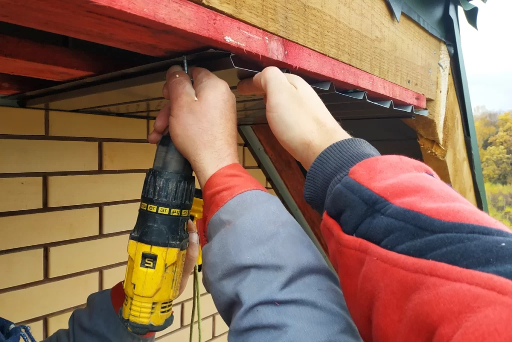 Close up view of roof eaves repair using tools