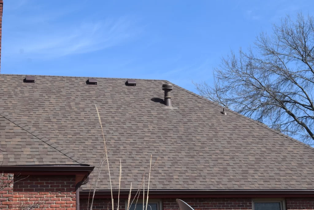 asphalt shingle roof of the house with a roof ventilation system