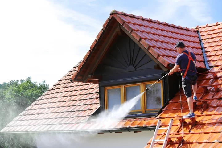 Roofer washing a beautiful roof