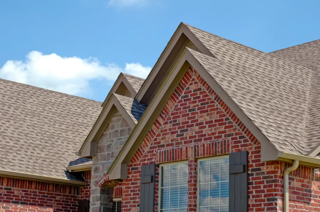 brick house with architectural shingles