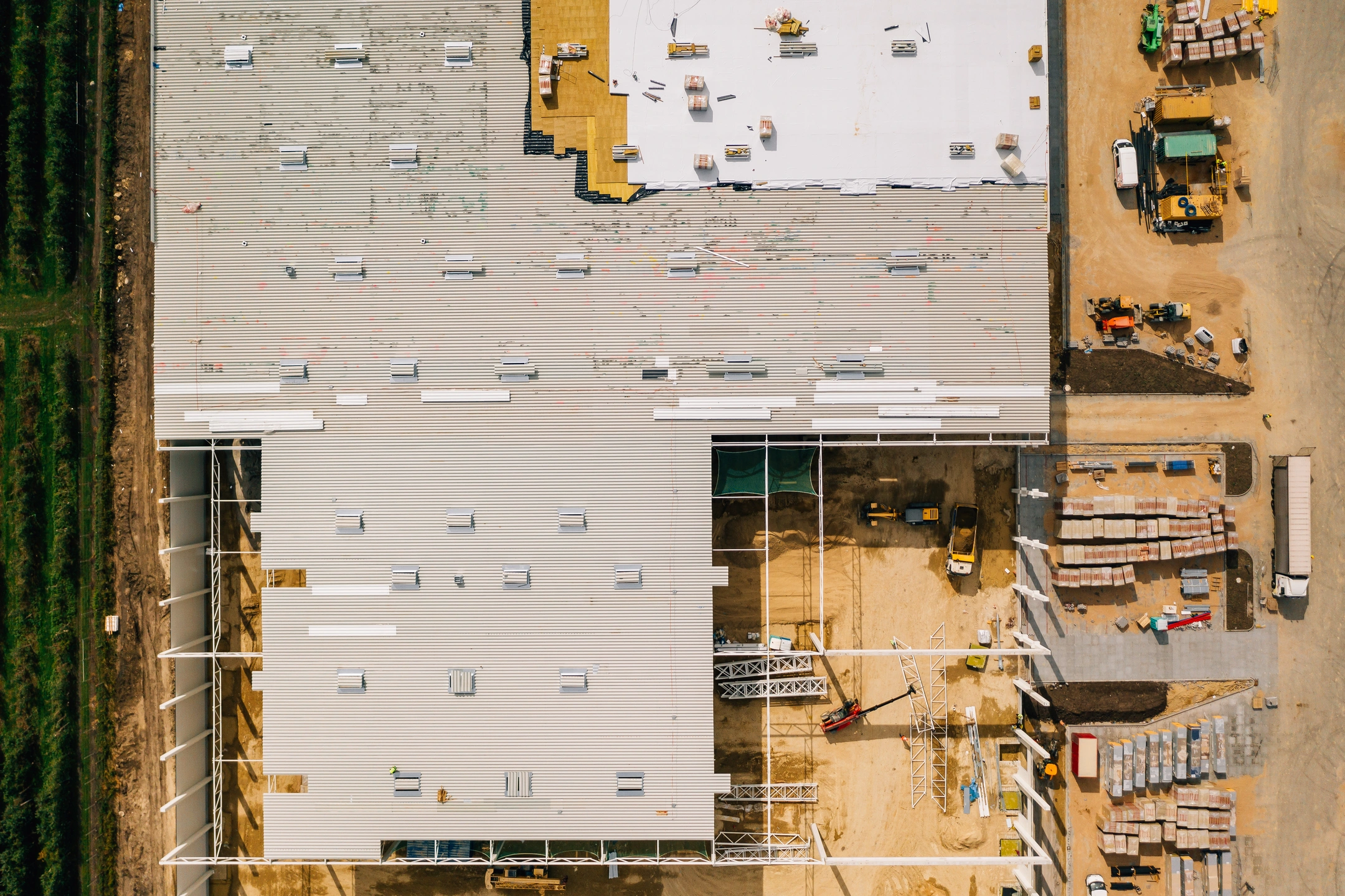 arial view of commercial roof being installed with manufactured materials