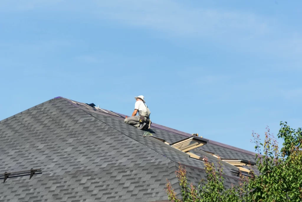 Contractor Installs Commercial Roof Shingles 1024x683.webp