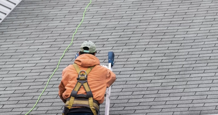 contractor inspecting roof damage for emergency repairs