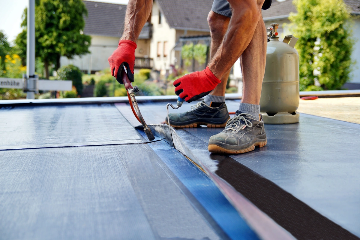 commercial roofing contractor repairs flat roof