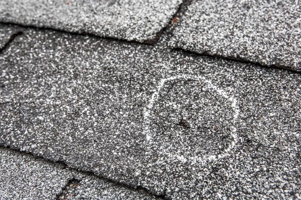 hail dent on asphalt shingles