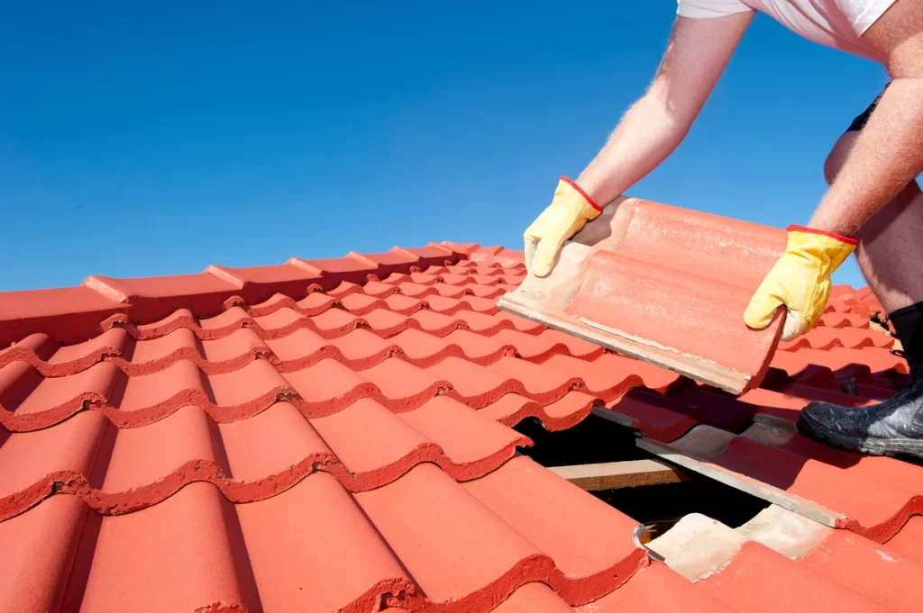 A roofer installs tile roof