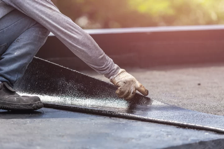 laying out flat roofing material