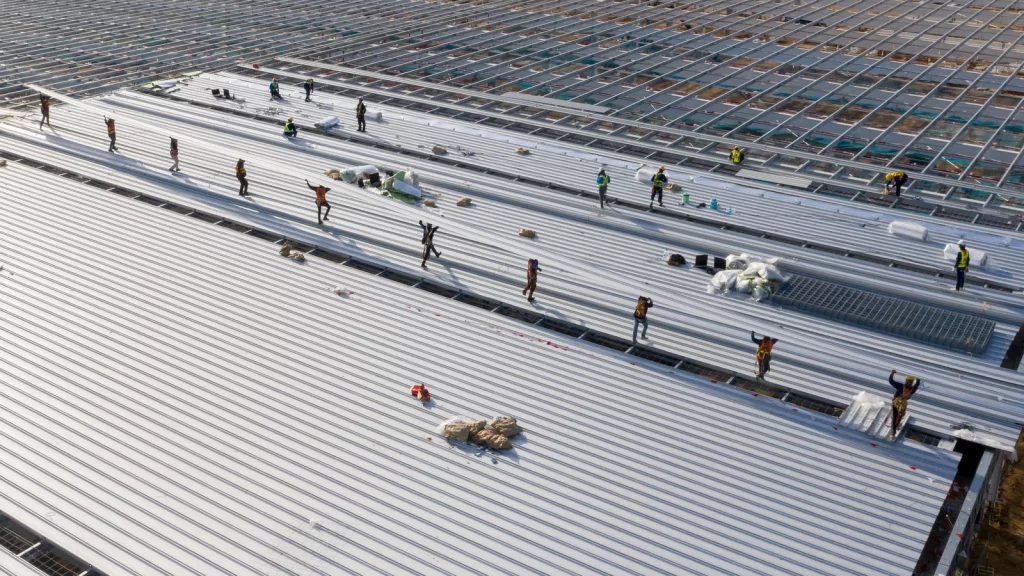 Aerial view of large commercial roofing system made of metal materials.