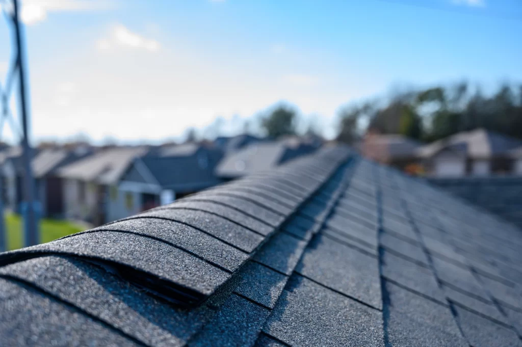 close up view of roof ridge cap shingles along ridge of roofing system