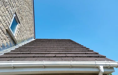 roof flashing between a sloped roof and a wall of a home