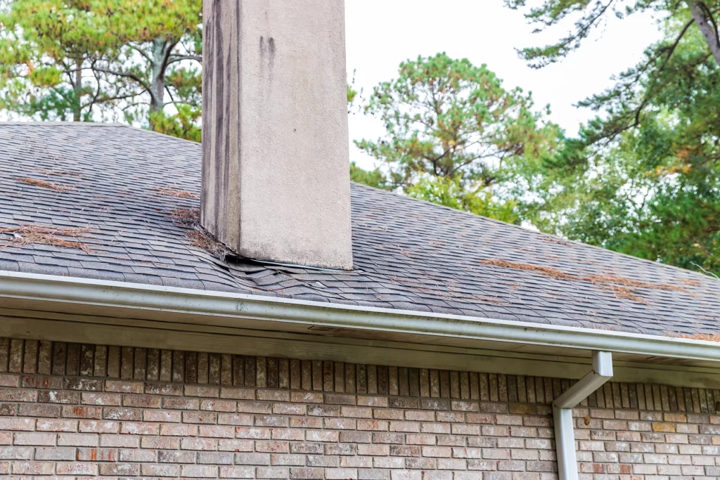 Closeup of shingle roof with damage in need of roof replacement insurance