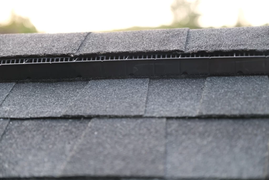 close up of roof ridge cap and ridge vent during new roof installation