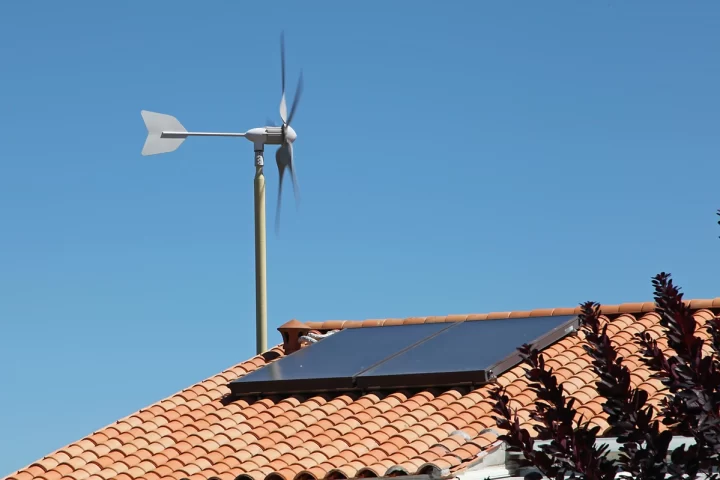 A solar panel and a windmill on a roof