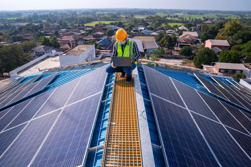 Aerial view of roofing contractor assessing solar panel installation