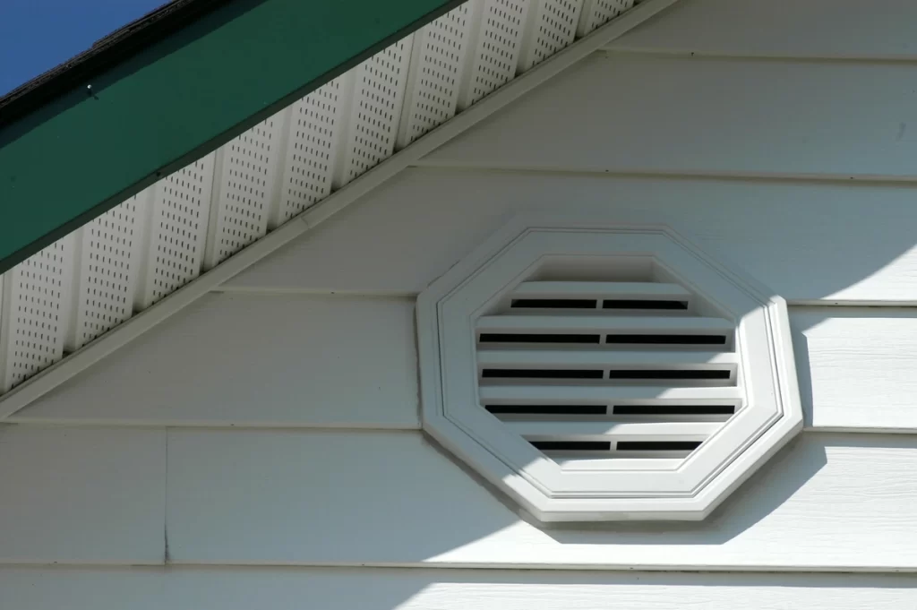 soffit ventilation on white vinyl siding house